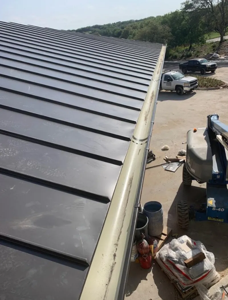 Standing seam panel and gutter detail on a metal roofing jobsite in Salem